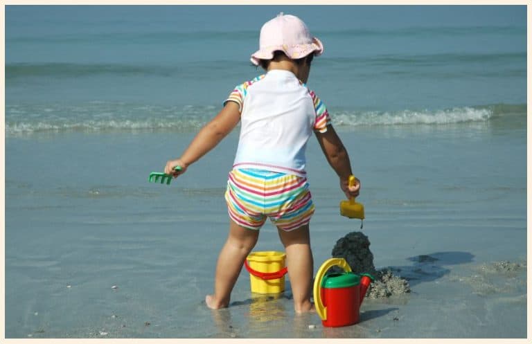 Toddler playing with toys at the beach