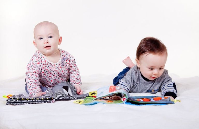 Babies playing with fabric books