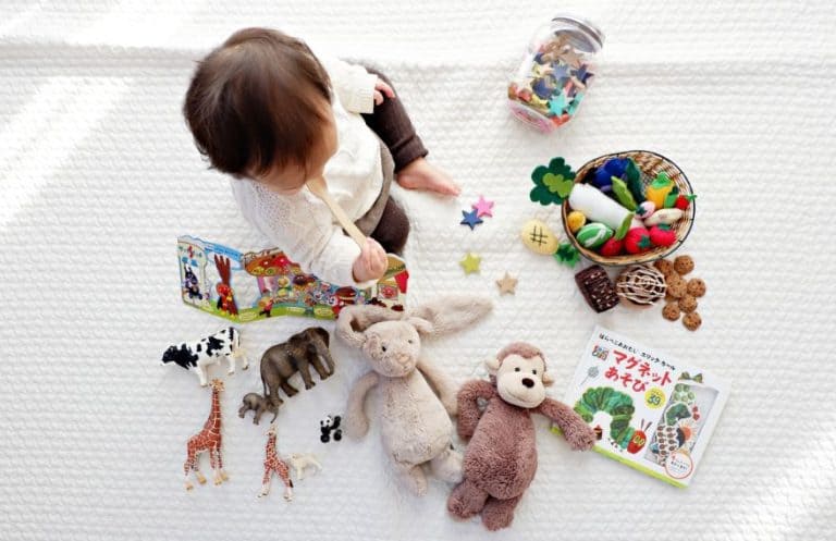 A child playing with books and toys