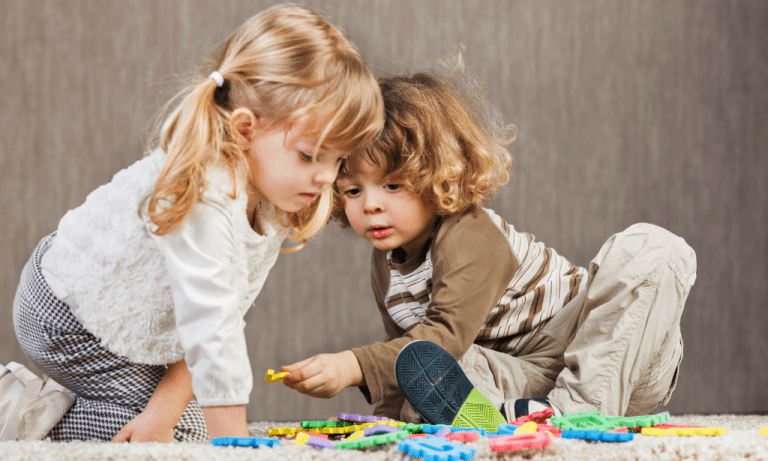 A boy giving a girl a puzzle piece