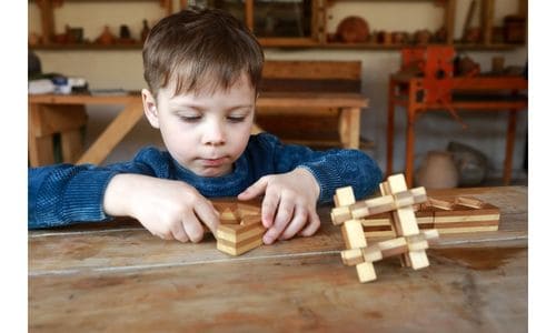 A boy solving a 3-D puzzle