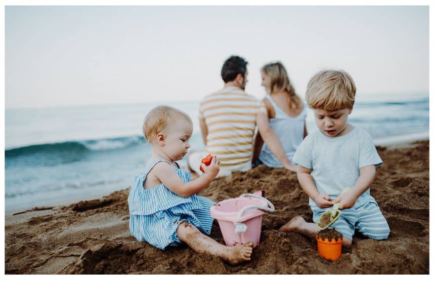 Toddlers playing with beach toys
