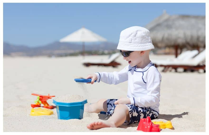 A boy playing with beach toys 