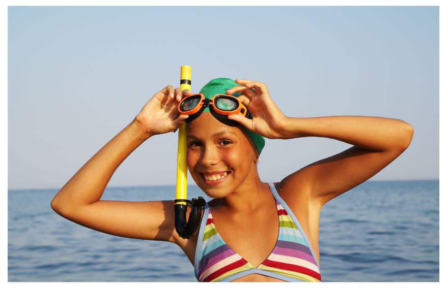 A girls at the beach with snorkeling glasses