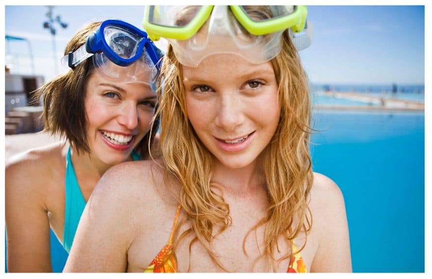 A teen girl at the beach with her mother