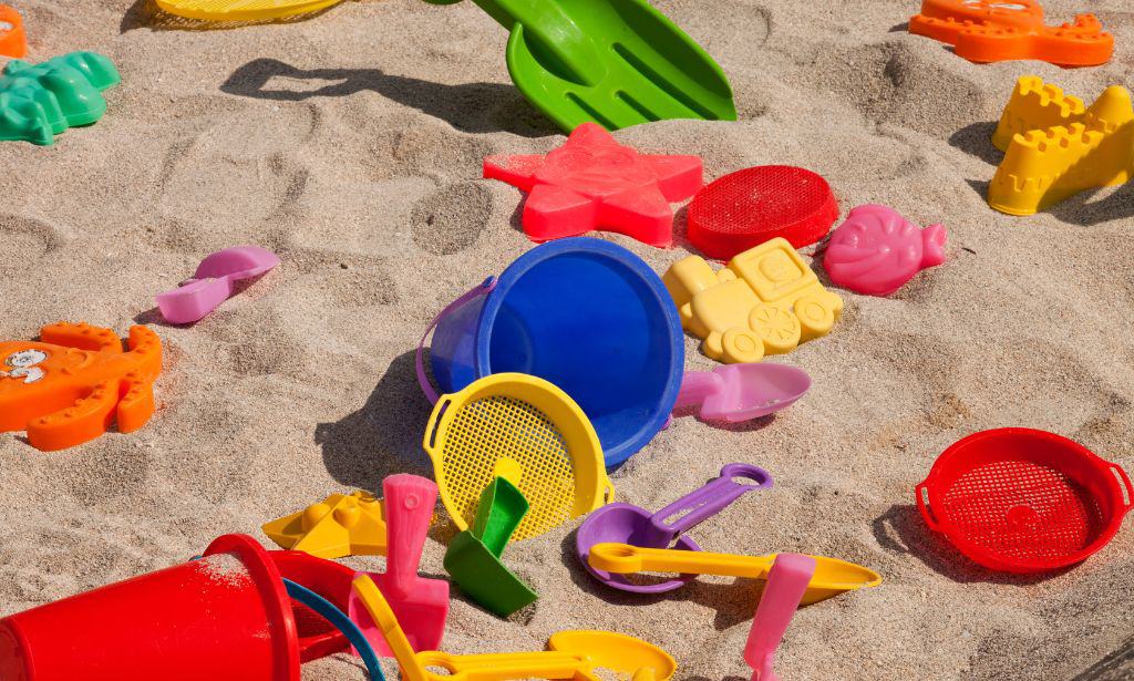 Colorful beach toys on the sand