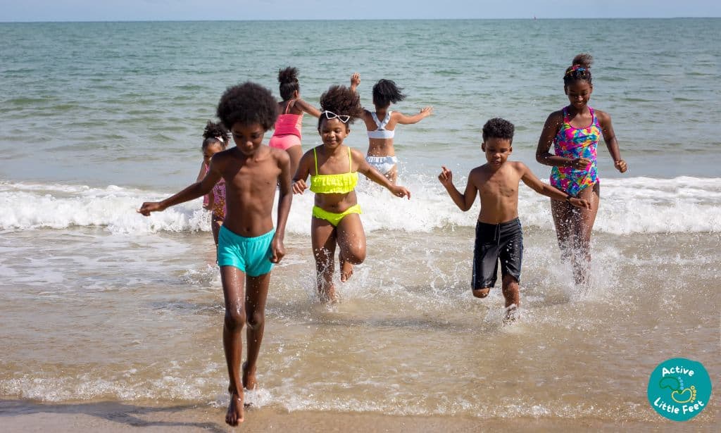 Kids running on the beach having fun